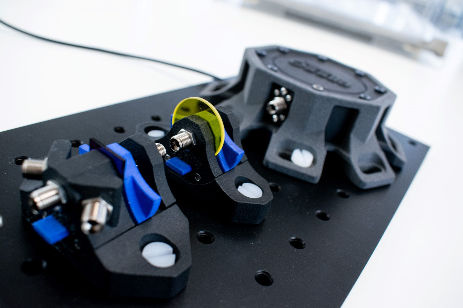 Fluorescence spectroscopy set up with four-port sample holder and optical filters